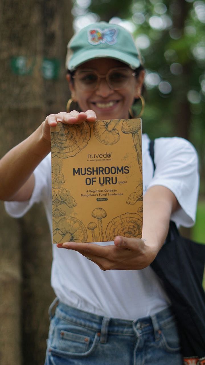 Co-founder of Nuvedo, Prithvi Kini, holds up a copy of the Mushrooms of Uru